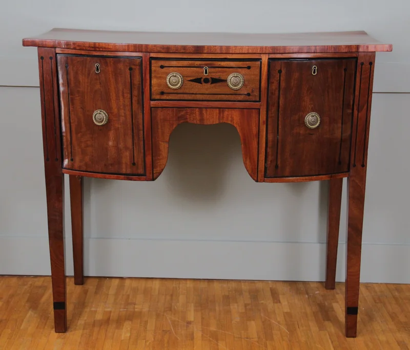 Late georgean sideboard - Meubel › Kasten - €880.00 - Klein formaat sideboard in mahonie met ebbenhouten inlegwerk. Handgepolitoerd.
Eén deur links, één lade in het midden, één diepe lade rechts.
99 x 45cm; 87cm hoog